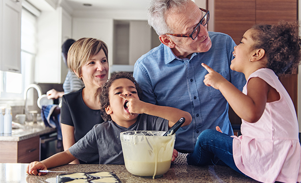 A biracial family making cookies together